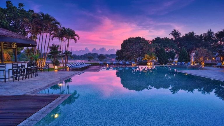Azerai La Residence Hue and its riverside pool at dusk | Source: KAYAK