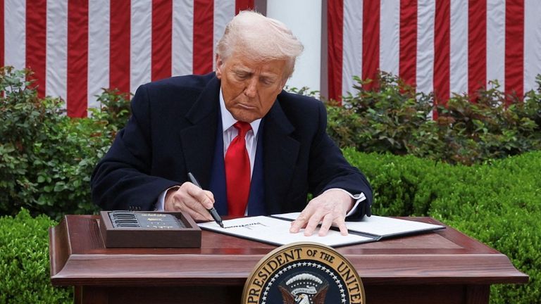 President Trump signs his new tariff policy into law. | Source: Reuters.