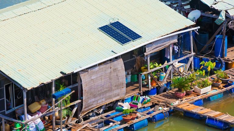 A floating house with solar batteries at a fish breeding farm. | Source: Shutterstock