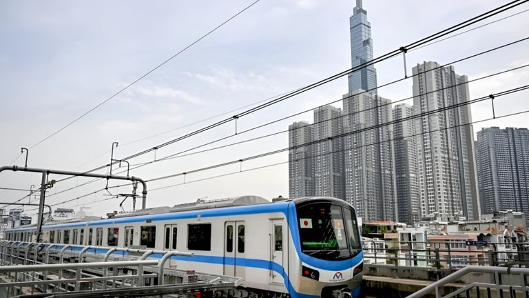 A train on the HCMC Metro's Line 1 passes by a residential area in Ho Chi Minh City. | Source: Nhac Nguyen/AFP
